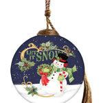 Hand-painted glass ornament featuring a joyful snowman with a wreath and candy cane, against a snowy night sky with "Let It Snow" in festive script.