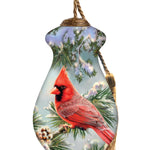 Hand-painted glass ornament featuring a red cardinal perched in frosty pine branches with snow-covered pinecones.