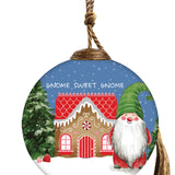 Hand-painted glass ornament featuring a gingerbread house and a gnome with the text "Gnome Sweet Gnome."