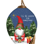Hand-painted glass ornament featuring a gnome with a lantern in a snowy forest scene with the text "I'll Be Gnome for Christmas."