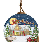 Hand-painted glass ornament featuring Santa flying in his sleigh over a snow-covered workshop, surrounded by festive Christmas trees and presents.