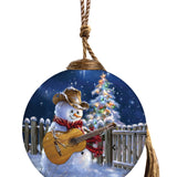 Hand-painted glass ornament featuring a cowboy snowman with a guitar under a starry Christmas night.