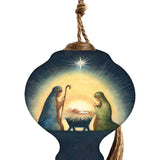 Hand-painted glass ornament depicting the Nativity scene with Mary, Joseph, and baby Jesus under a shining star in a peaceful, radiant setting.